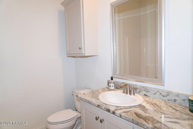 bathroom featuring vanity, a shower, and toilet