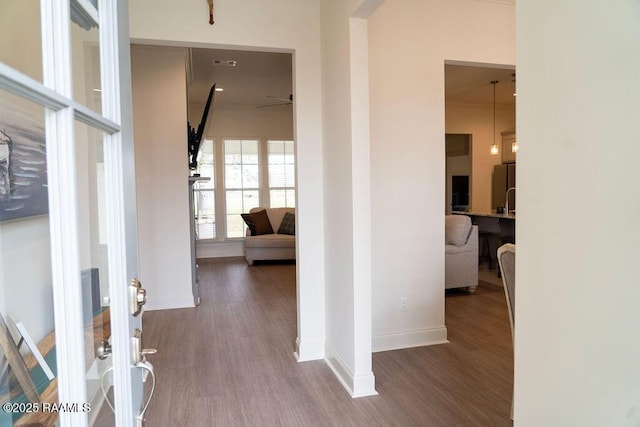 hallway with hardwood / wood-style floors