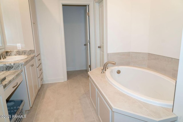 bathroom with vanity, tile patterned flooring, and a tub