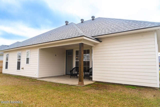 back of house featuring a patio area and a lawn