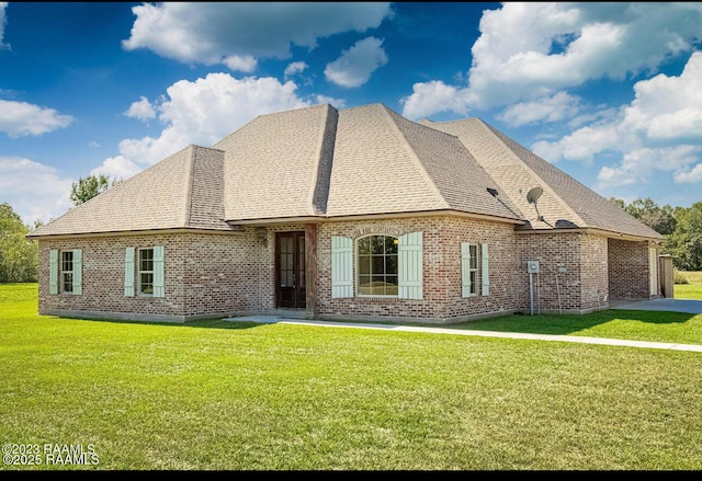 rear view of property featuring a yard