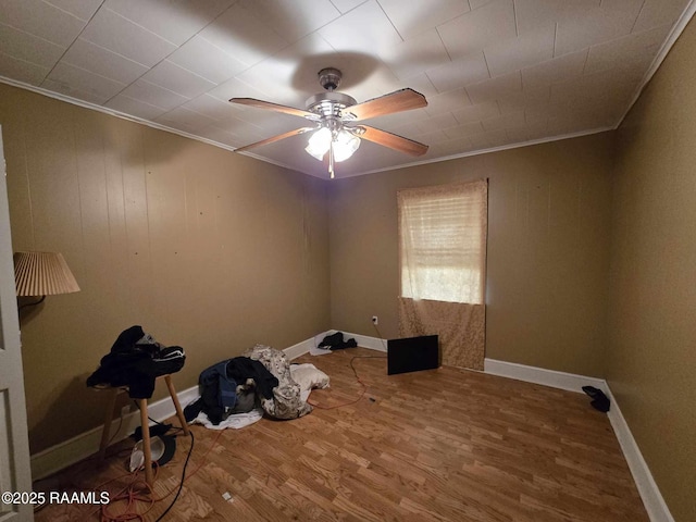 spare room with crown molding, ceiling fan, and wood-type flooring