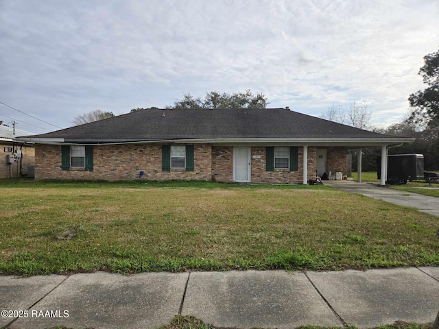 ranch-style house featuring central AC, a front lawn, and a carport