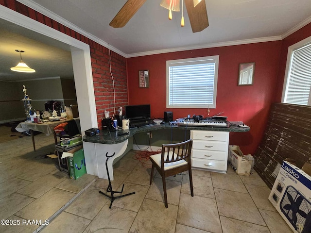 home office with ornamental molding, plenty of natural light, built in desk, and ceiling fan