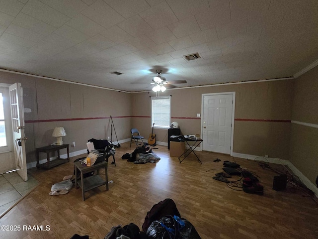 exercise area with crown molding, ceiling fan, and hardwood / wood-style floors