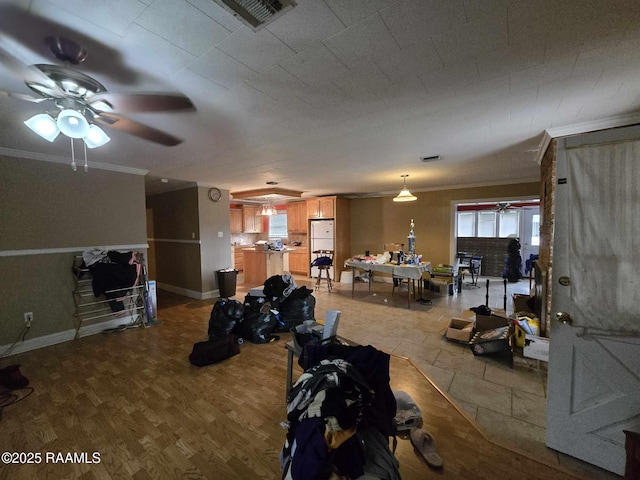 interior space featuring ornamental molding, ceiling fan, and light hardwood / wood-style floors