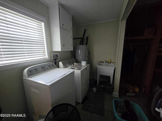 laundry area with cabinets, sink, washer and clothes dryer, and electric water heater