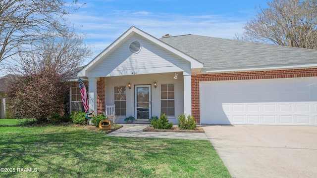 view of front facade with a front yard, driveway, an attached garage, covered porch, and brick siding