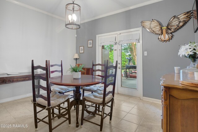 dining area featuring crown molding, light tile patterned flooring, and baseboards