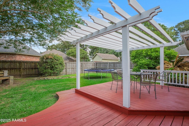 deck with a lawn, a pergola, outdoor dining area, and a fenced backyard