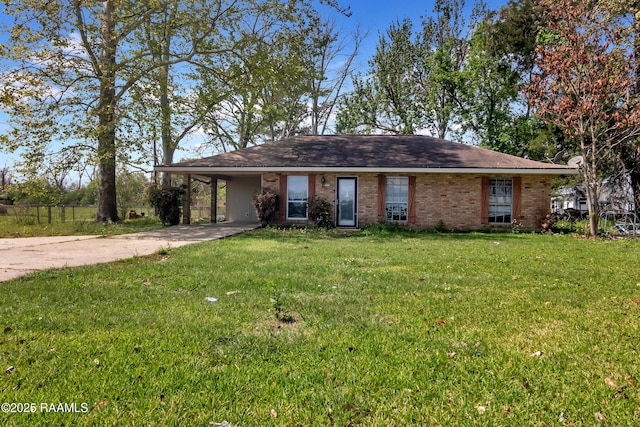 view of front facade featuring driveway, brick siding, a front lawn, and a carport