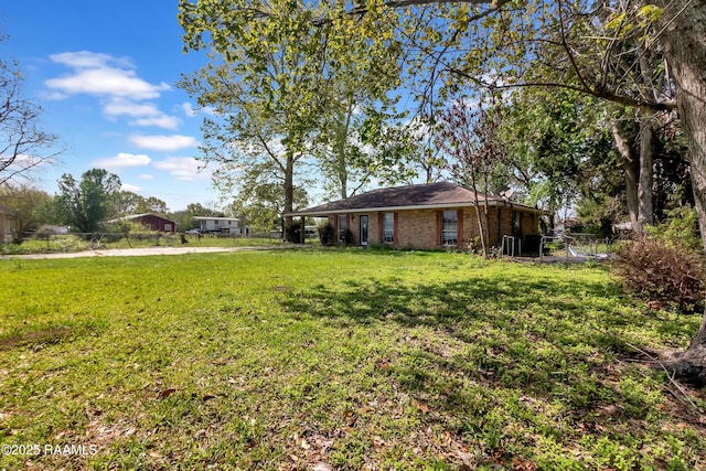 view of yard with a carport and fence
