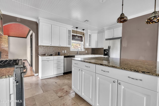 kitchen featuring decorative backsplash, white cabinets, visible vents, stainless steel appliances, and arched walkways