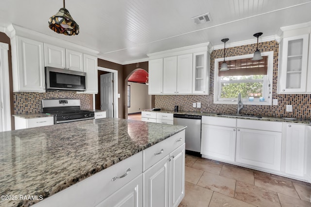 kitchen with white cabinets, a sink, appliances with stainless steel finishes, and visible vents
