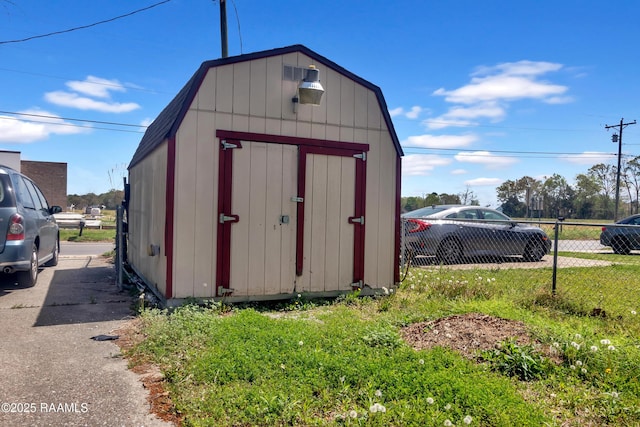 view of shed featuring fence