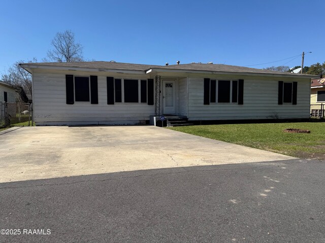 ranch-style home with a front yard and driveway