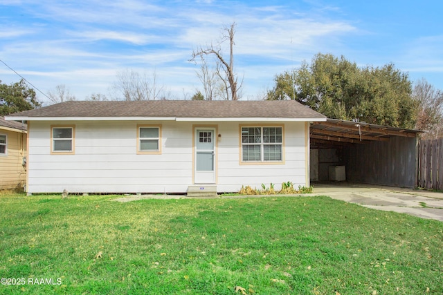 ranch-style house with a front lawn and a carport