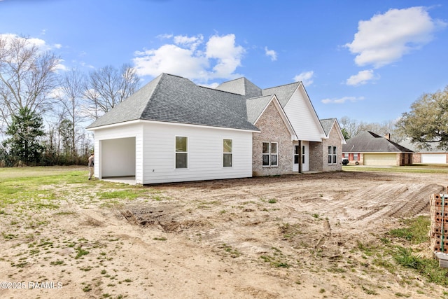 back of property featuring a garage