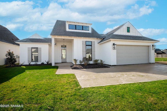 view of front of property with a garage and a front lawn