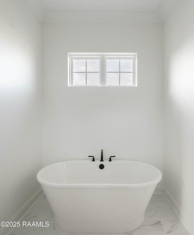 bathroom featuring a tub and a wealth of natural light