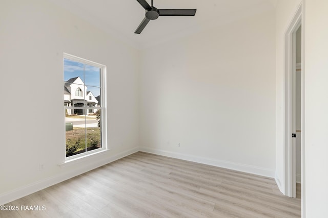 spare room featuring plenty of natural light, ceiling fan, and light wood-type flooring