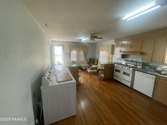 kitchen featuring dishwasher, ceiling fan, double oven range, dark hardwood / wood-style floors, and washer / dryer