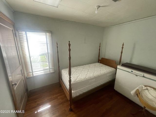 bedroom with dark hardwood / wood-style floors