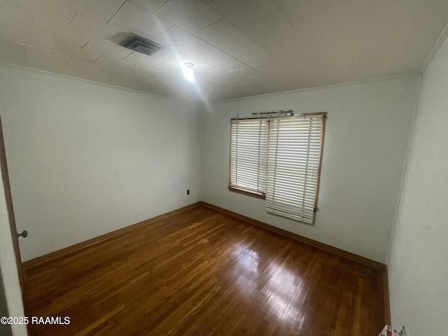 spare room featuring ornamental molding and wood-type flooring