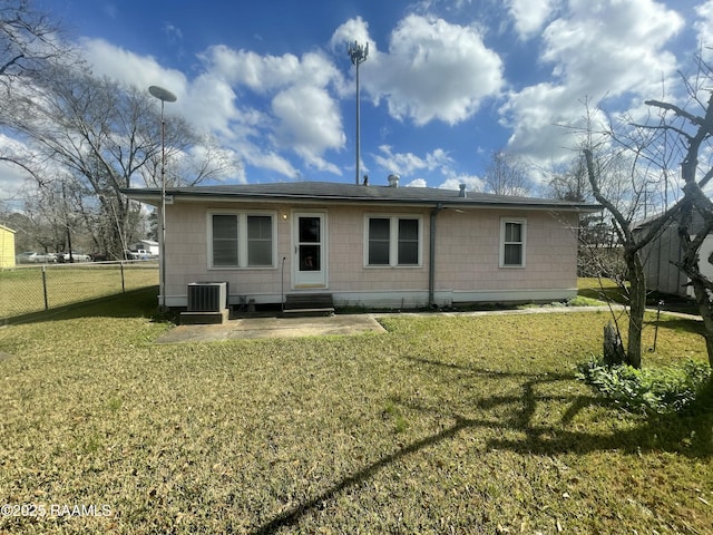 rear view of property with a patio area and a lawn