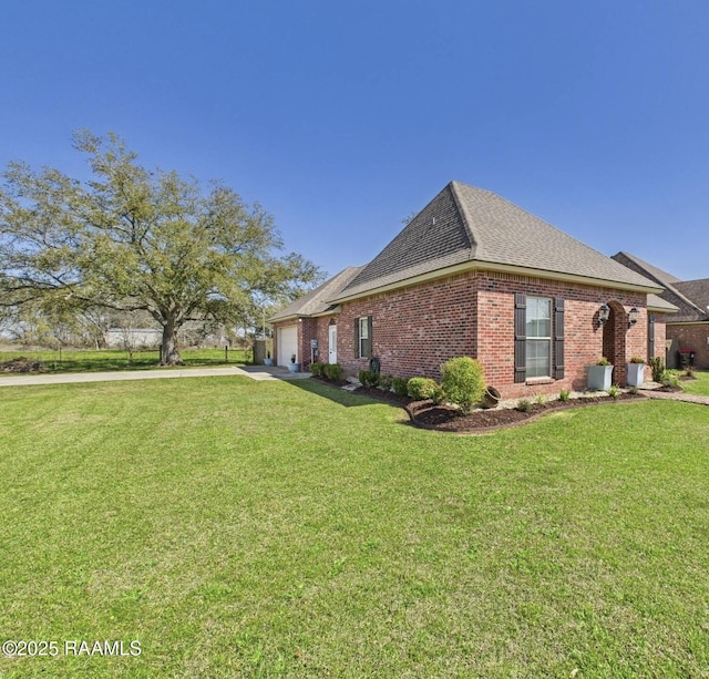 view of property exterior with concrete driveway, a garage, brick siding, and a yard