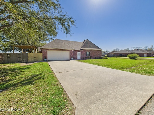 view of front of house featuring a gate, fence, a front yard, a garage, and brick siding