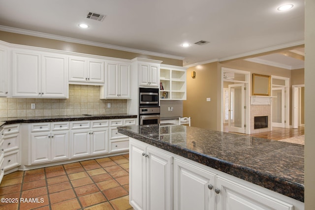 kitchen featuring visible vents, backsplash, appliances with stainless steel finishes, white cabinetry, and open shelves