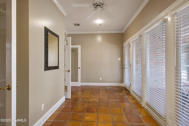 hall featuring tile patterned floors, visible vents, baseboards, and crown molding