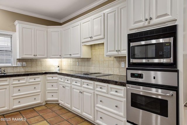 kitchen with white cabinetry, tasteful backsplash, appliances with stainless steel finishes, and ornamental molding