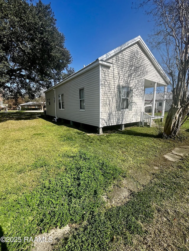 view of side of property with a yard