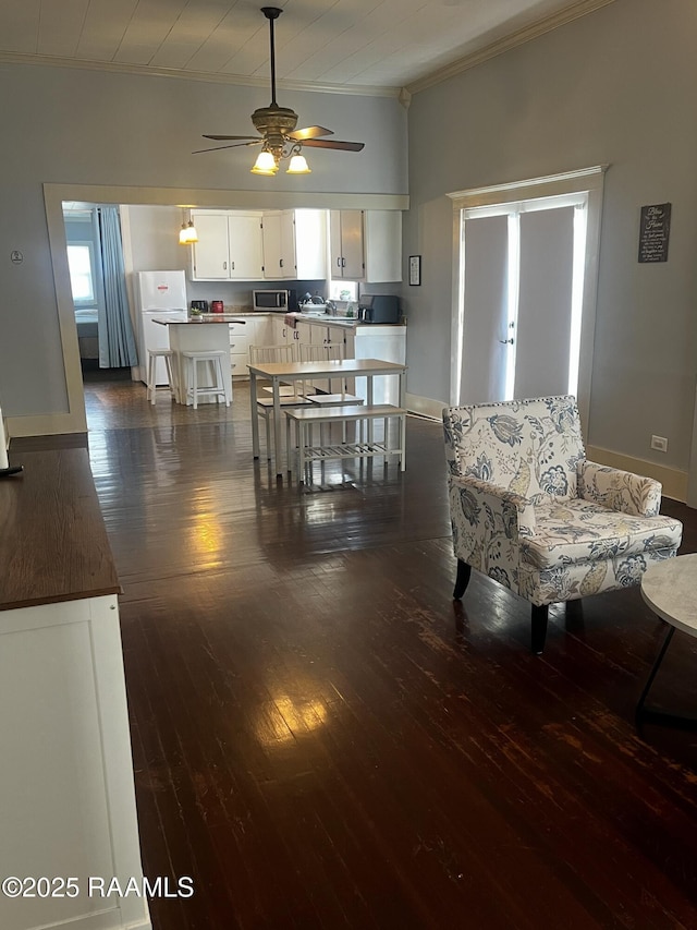 dining space featuring ornamental molding, dark hardwood / wood-style floors, and ceiling fan