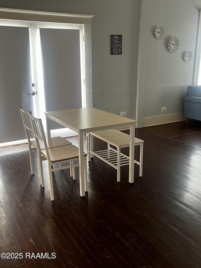 unfurnished dining area with dark wood-type flooring