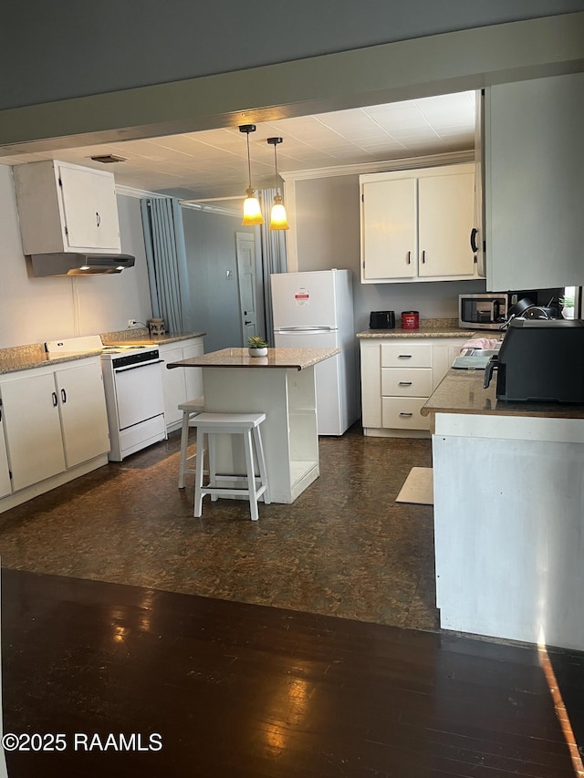 kitchen featuring white cabinetry, a center island, pendant lighting, and white appliances