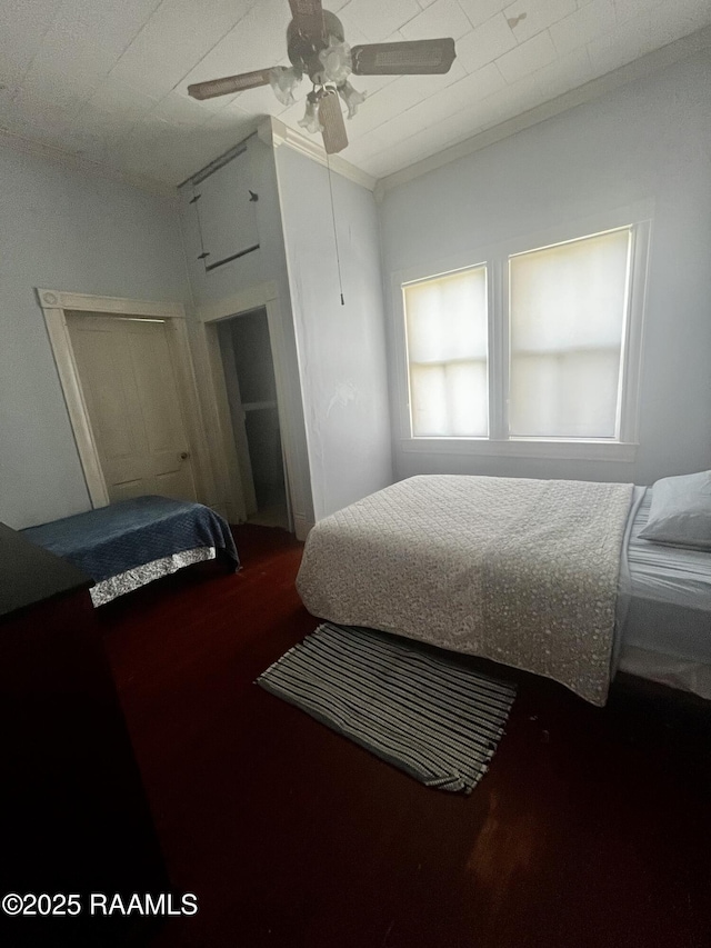 bedroom with ornamental molding and ceiling fan