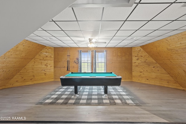 rec room with hardwood / wood-style floors, a drop ceiling, pool table, and wood walls