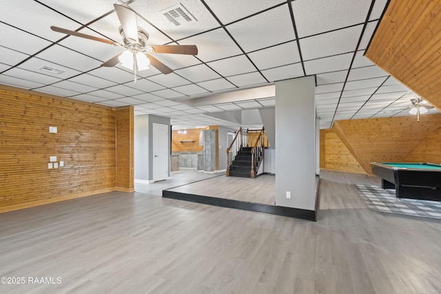 interior space with wood-type flooring, a paneled ceiling, pool table, and wood walls