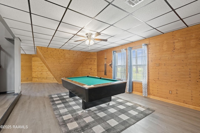 playroom with billiards, wood-type flooring, wooden walls, and a drop ceiling