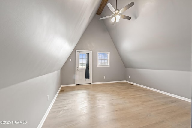 additional living space featuring lofted ceiling with beams, ceiling fan, and light hardwood / wood-style floors