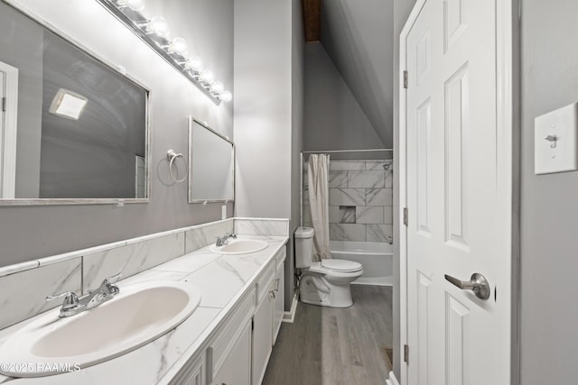 full bathroom with wood-type flooring, vanity, shower / tub combo, and toilet