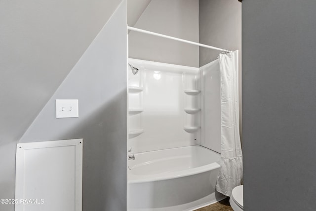 bathroom with shower / bath combo and toilet