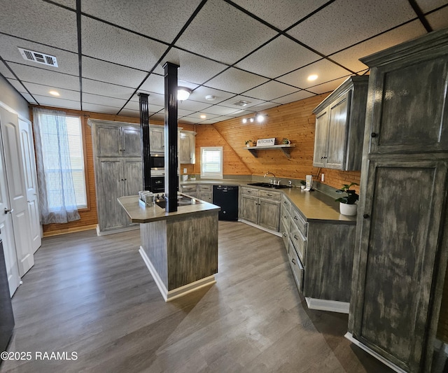 kitchen featuring sink, black appliances, dark hardwood / wood-style floors, and a kitchen island