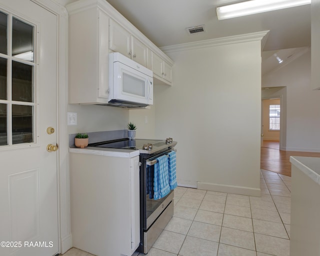 kitchen featuring crown molding, light tile patterned floors, stainless steel range with electric cooktop, and white cabinets