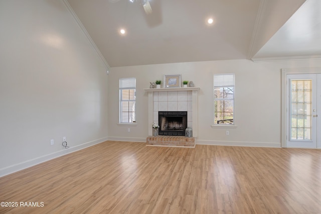 unfurnished living room with crown molding, light hardwood / wood-style flooring, and a wealth of natural light