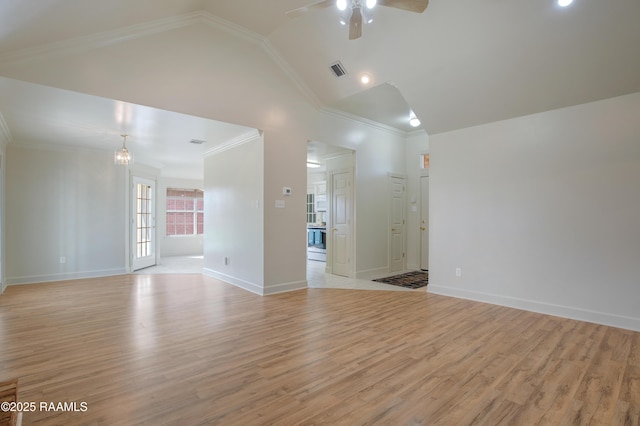 empty room featuring vaulted ceiling, crown molding, ceiling fan, and light wood-type flooring