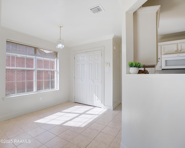 unfurnished dining area featuring ornamental molding, a chandelier, and light tile patterned floors